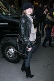 Miley Cyrus in black leather jacket and boots